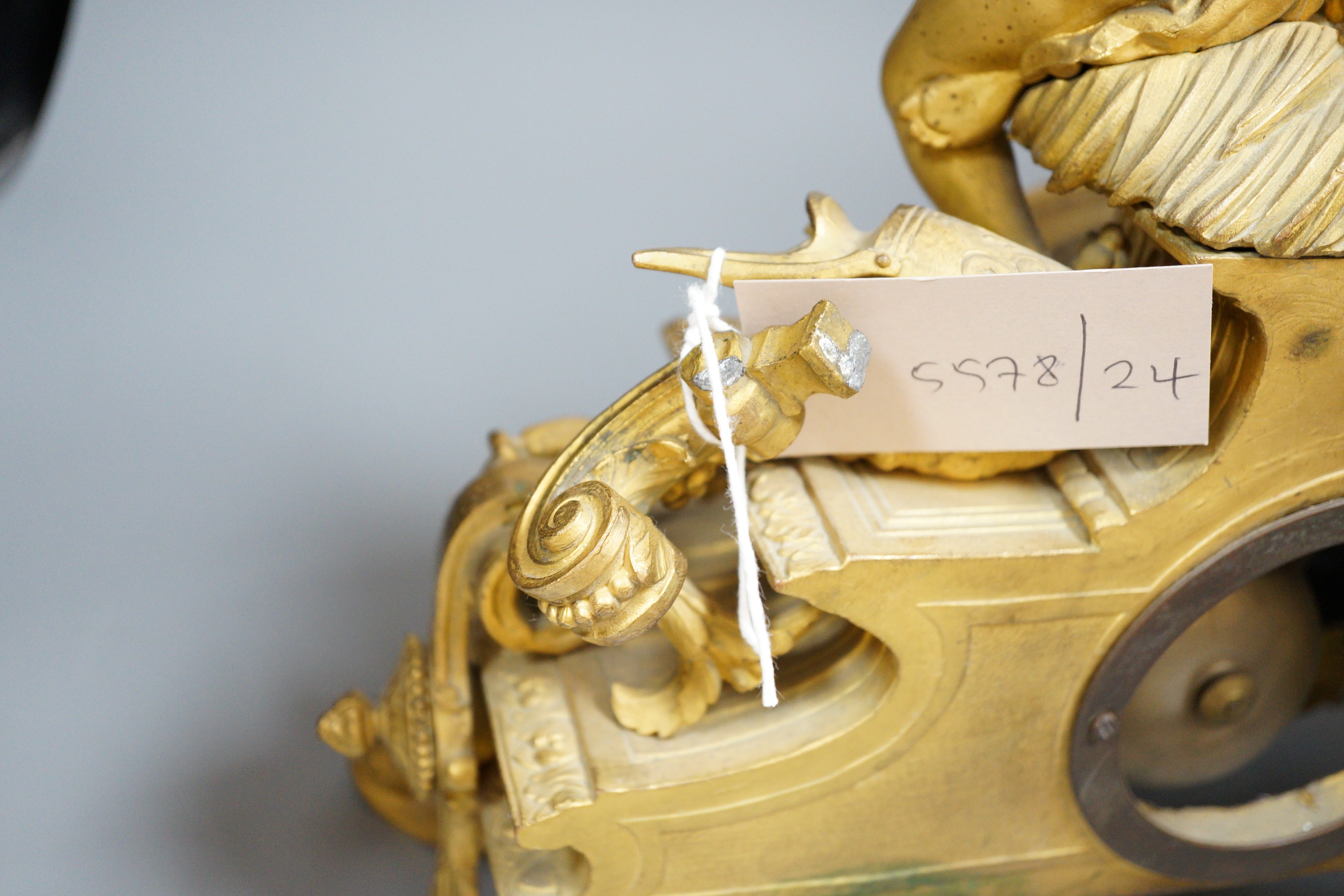 A French putti mounted spelter mantel clock, 32cm
